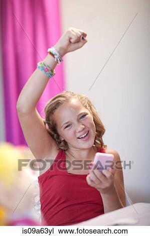 Cheering girl using cell phone View Large Photo Image Stock Image - Cheering girl using cell phone. Fotosearch
