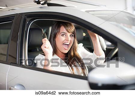 Stock Image - Cheering woman buying new car. Fotosearch