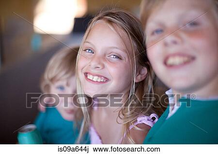 Stock Image - Children drinking soda in garage. Fotosearch