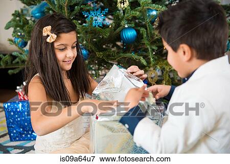 Children opening Christmas present View Large Photo Image Stock Photo - Children opening Christmas present. Fotosearch