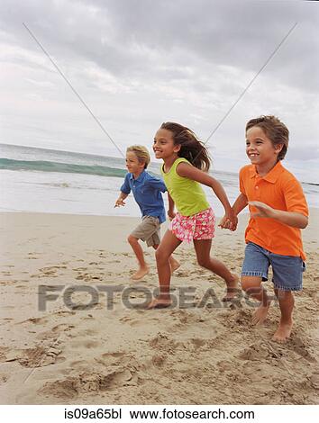 Children running together on beach View Large Photo Image Stock Image - Children running together on beach. Fotosearch