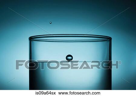 Close up of drop in glass of water View Large Photo Image Stock Photo - Close up of drop in glass of water. Fotosearch