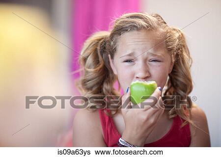 Stock Photograph - Close up of girl eating apple. Fotosearch