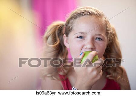Stock Photography - Close up of girl eating apple. Fotosearch