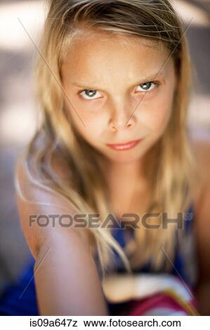 Stock Photo - Close up of girl's angry face. Fotosearch