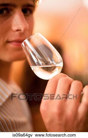 Stock Photo - Close up of man tasting wine. Fotosearch