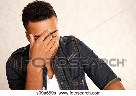 Stock Photograph - Close up of man's frustrated face. Fotosearch