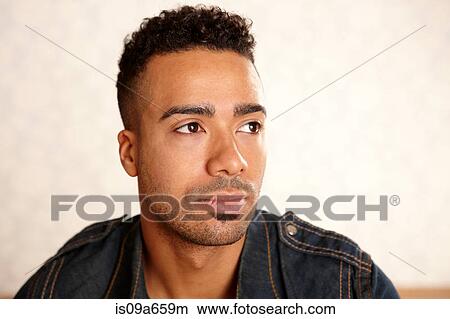 Picture - Close up of man's serious face. Fotosearch