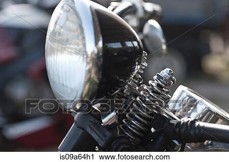 Stock Image - Close up of motorcycle headlight. Fotosearch