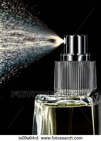 Stock Image - Close up of perfume spraying from bottle. Fotosearch