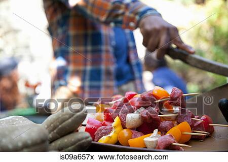 Stock Photo - Close up of raw kebabs by grill. Fotosearch