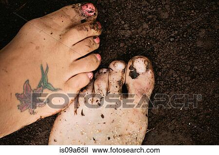 Stock Image - Close up of toes in dirt. Fotosearch