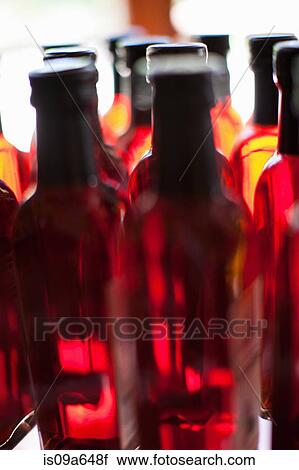 Stock Image - Close up of vinegar bottles on shelf. Fotosearch