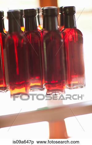 Stock Photography - Close up of vinegar bottles on shelf. Fotosearch