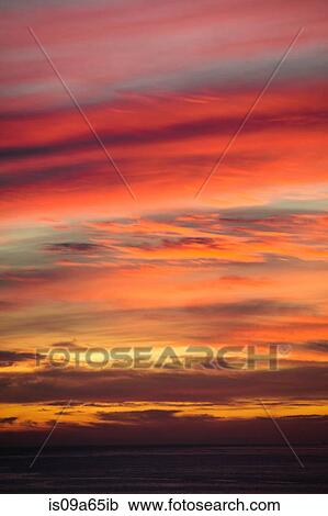 Clouds in colorful sunset sky View Large Photo Image Stock Image - Clouds in colorful sunset sky. Fotosearch
