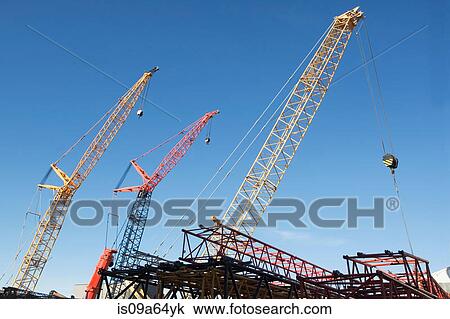 Colorful cranes against blue sky View Large Photo Image Stock Image - Colorful cranes against blue sky. Fotosearch