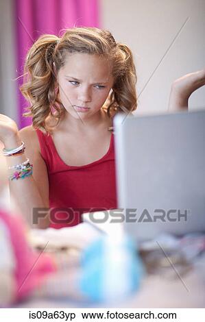 Stock Photography - Confused girl using laptop. Fotosearch