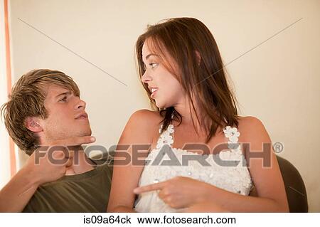 Stock Image - Couple arguing on sofa. Fotosearch