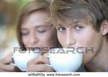 Couple drinking coffee together outdoors View Large Photo Image Stock Photography - Couple drinking coffee together outdoors. Fotosearch
