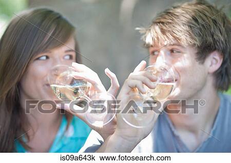 Stock Image - Couple drinking wine together outdoors. Fotosearch