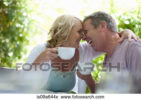Stock Photo - Couple having coffee together outdoors. Fotosearch