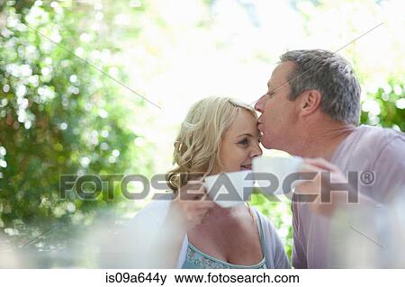 Stock Photo - Couple having coffee together outdoors. Fotosearch