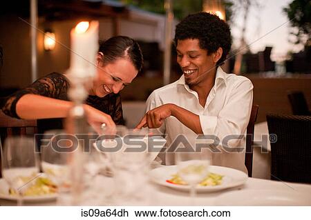 Couple having dinner in restaurant View Large Photo Image Stock Image - Couple having dinner in restaurant. Fotosearch