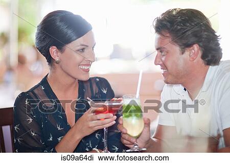 Stock Image - Couple having drinks at restaurant. Fotosearch