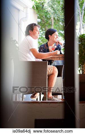 Couple having drinks together on patio View Large Photo Image Stock Image - Couple having drinks together on patio. Fotosearch