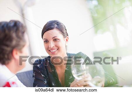 Couple having drinks together outdoors View Large Photo Image Stock Image - Couple having drinks together outdoors. Fotosearch