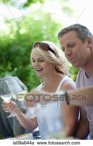 Couple having wine outdoors View Large Photo Image Stock Image - Couple having wine outdoors. Fotosearch