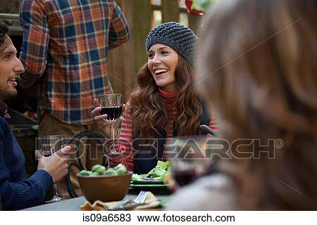 Stock Image - Couple having wine together outdoors. Fotosearch
