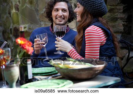 Couple having wine together outdoors View Large Photo Image Stock Photography - Couple having wine together outdoors. Fotosearch