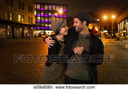 Picture - Couple hugging on city street. Fotosearch