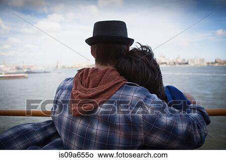 Couple hugging on ferry in urban harbor View Large Photo Image Picture - Couple hugging on ferry in urban harbor. Fotosearch