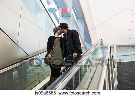 Couple kissing on escalator outdoors View Large Photo Image Stock Photography - Couple kissing on escalator outdoors. Fotosearch