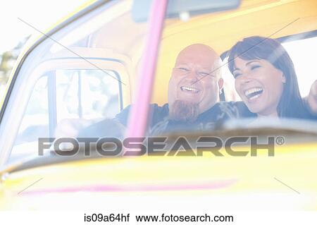 Couple laughing in colorful car View Large Photo Image Stock Image - Couple laughing in colorful car. Fotosearch