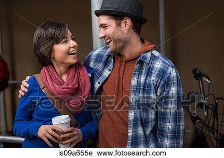 Couple laughing on city street View Large Photo Image Stock Image - Couple laughing on city street. Fotosearch