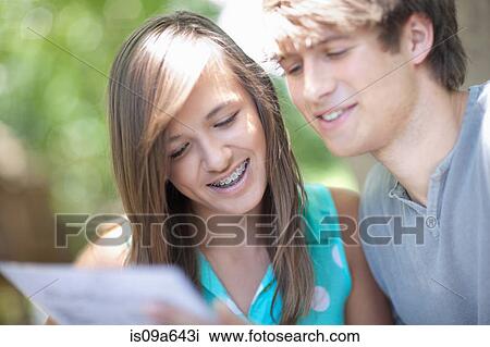Couple reading menu at table View Large Photo Image Stock Image - Couple reading menu at table. Fotosearch