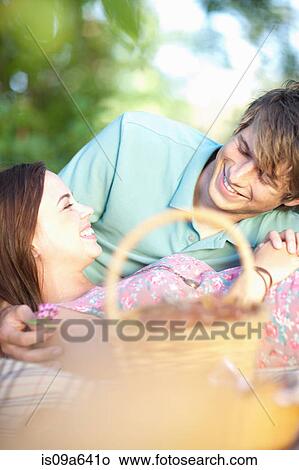 Couple relaxing on picnic blanket View Large Photo Image Picture - Couple relaxing on picnic blanket. Fotosearch