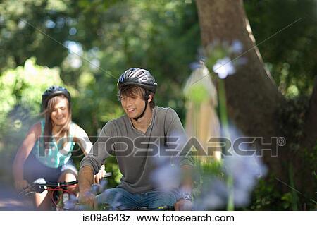 Couple riding mountain bikes together View Large Photo Image Stock Photo - Couple riding mountain bikes together. Fotosearch
