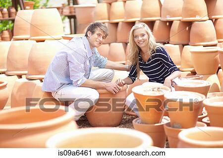 Stock Image - Couple shopping for planters. Fotosearch