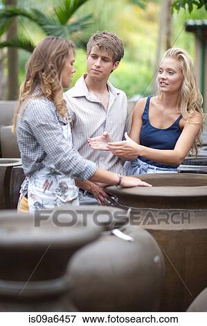 Stock Photo - Couple shopping for planters. Fotosearch
