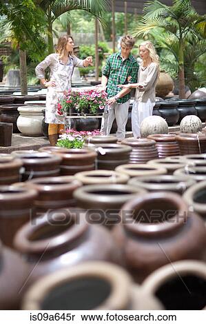 Stock Photography - Couple shopping for planters. Fotosearch