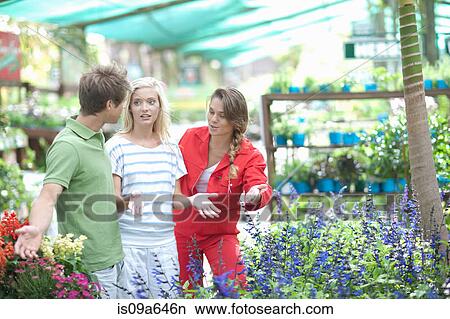 Picture - Couple shopping for plants in nursery. Fotosearch
