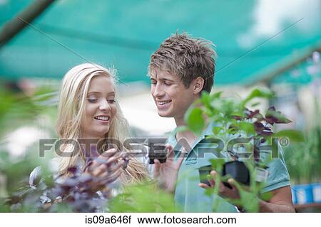 Couple shopping for plants in nursery View Large Photo Image Stock Image - Couple shopping for plants in nursery. Fotosearch