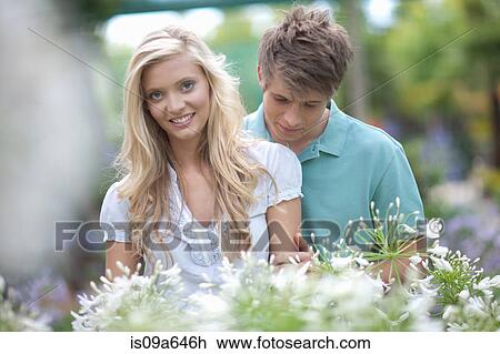 Couple shopping for plants in nursery View Large Photo Image Stock Image - Couple shopping for plants in nursery. Fotosearch