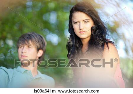Couple sitting together in park View Large Photo Image Picture - Couple sitting together in park. Fotosearch
