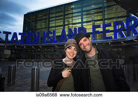 Stock Photo - Couple smiling by Staten Island Ferry. Fotosearch