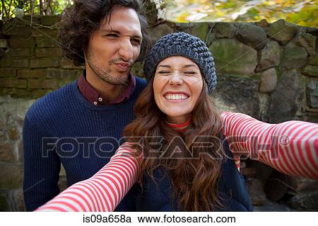 Couple taking picture together outdoors View Large Photo Image Stock Image - Couple taking picture together outdoors. Fotosearch